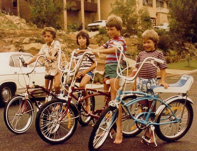 A photo from the 70s showing a group of young boys with their bicycles.