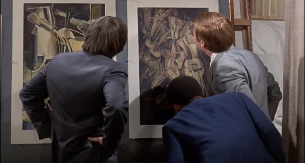 Movie still showing Dexter looking at a painting by Marcel Duchamp